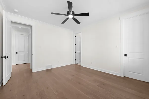 a view of empty room with wooden floor