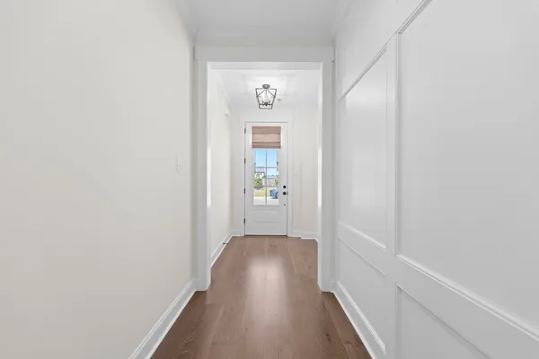 a view of a hallway with wooden floor
