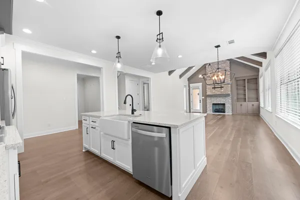 a large kitchen with sink a refrigerator and a stove