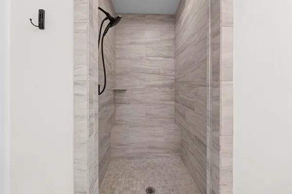 a bathroom with a glass shower door