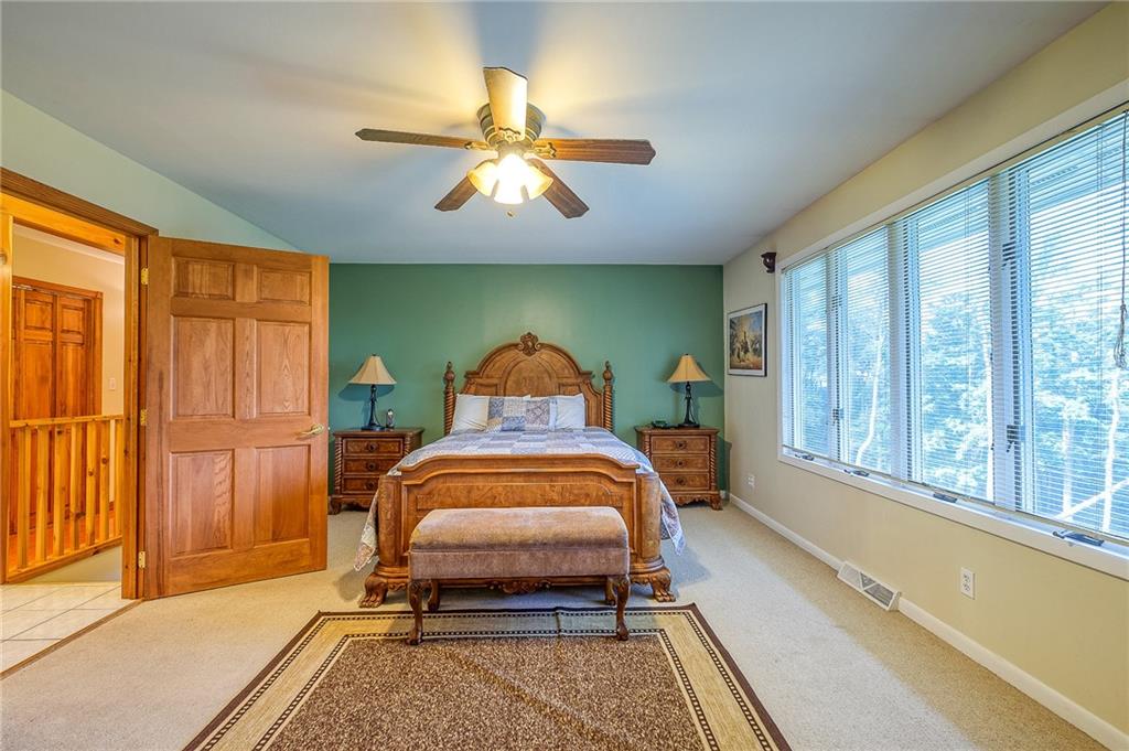 282 Alpine Heights Road Champion, PA 15622 - Photo 13 of 25 a bedroom with a bed and a window
