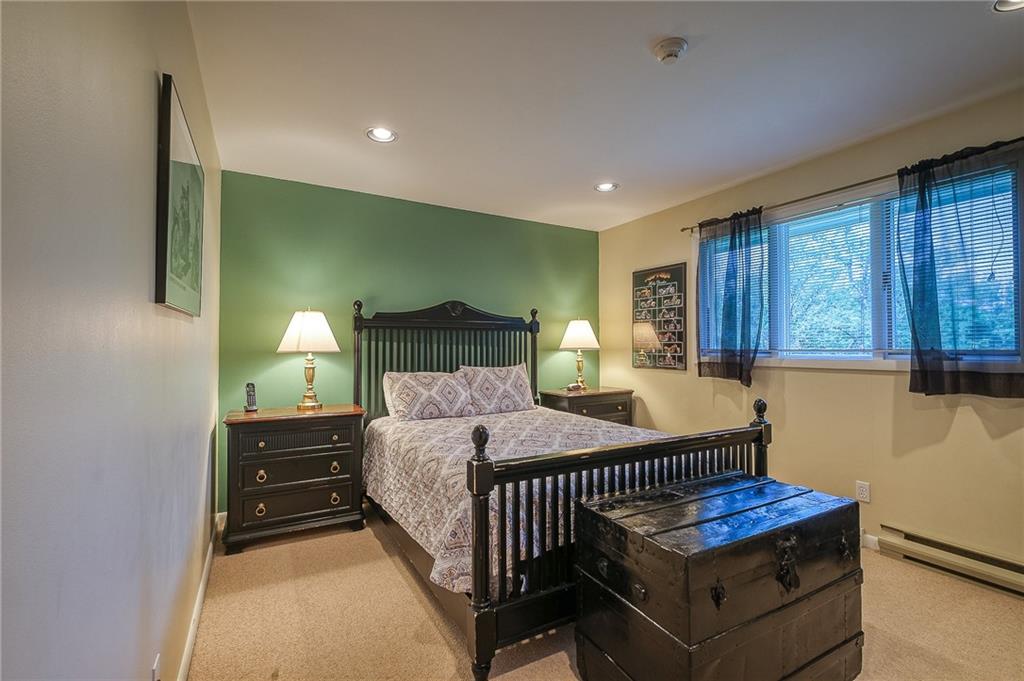 282 Alpine Heights Road Champion, PA 15622 - Photo 15 of 25 a bedroom with a bed and large windows