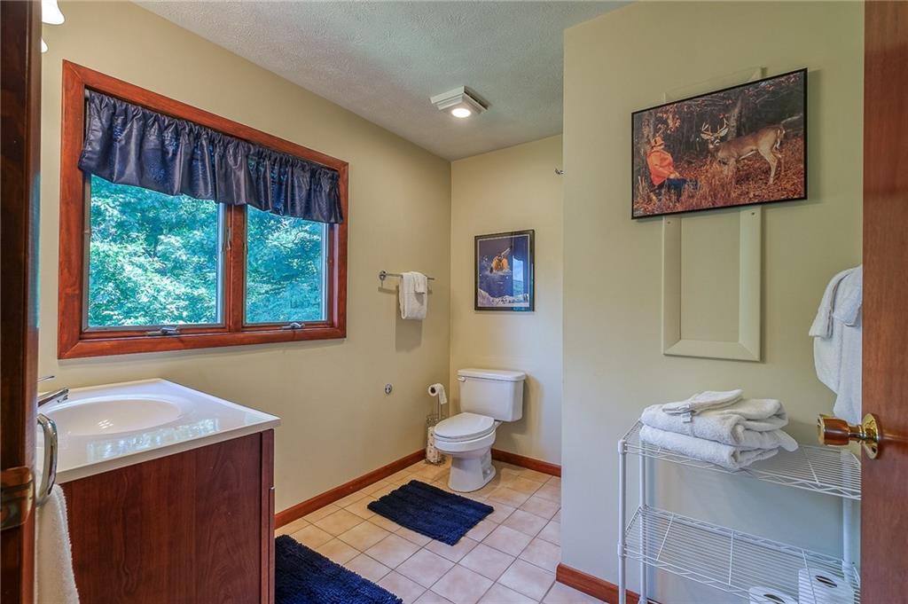 282 Alpine Heights Road Champion, PA 15622 - Photo 21 of 25 a bathroom with a toilet a sink and a window