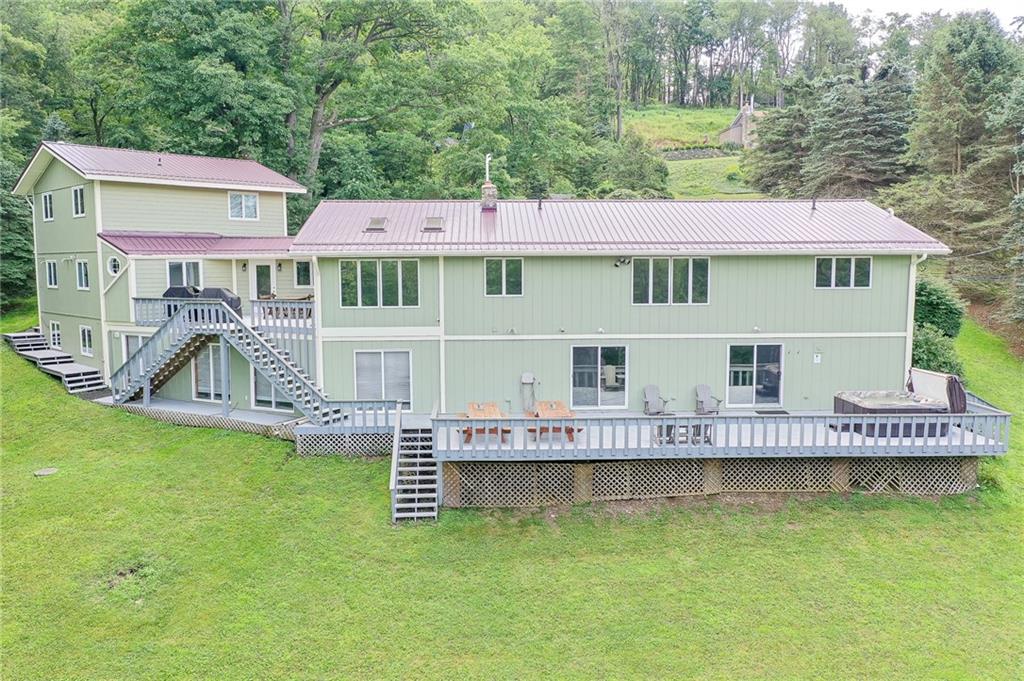 282 Alpine Heights Road Champion, PA 15622 - Photo 4 of 25 a front view of a house with a garden and deck