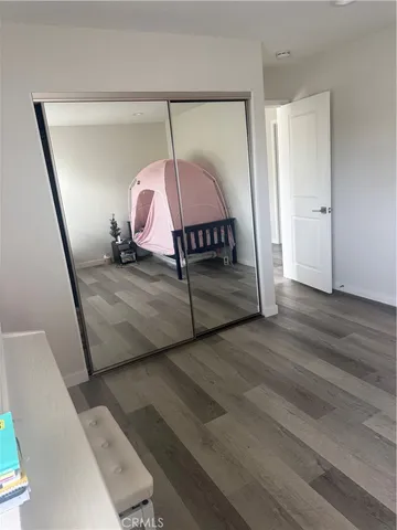 a view of a room wooden floor windows and entryway