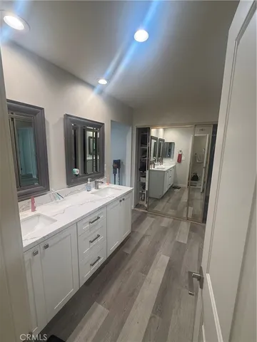 a spacious bathroom with a double vanity sink and a mirror