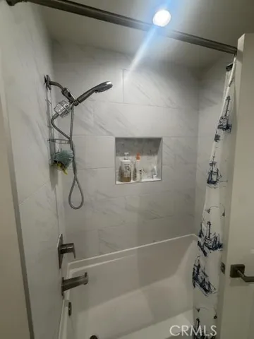 a bathroom with a shower and tub