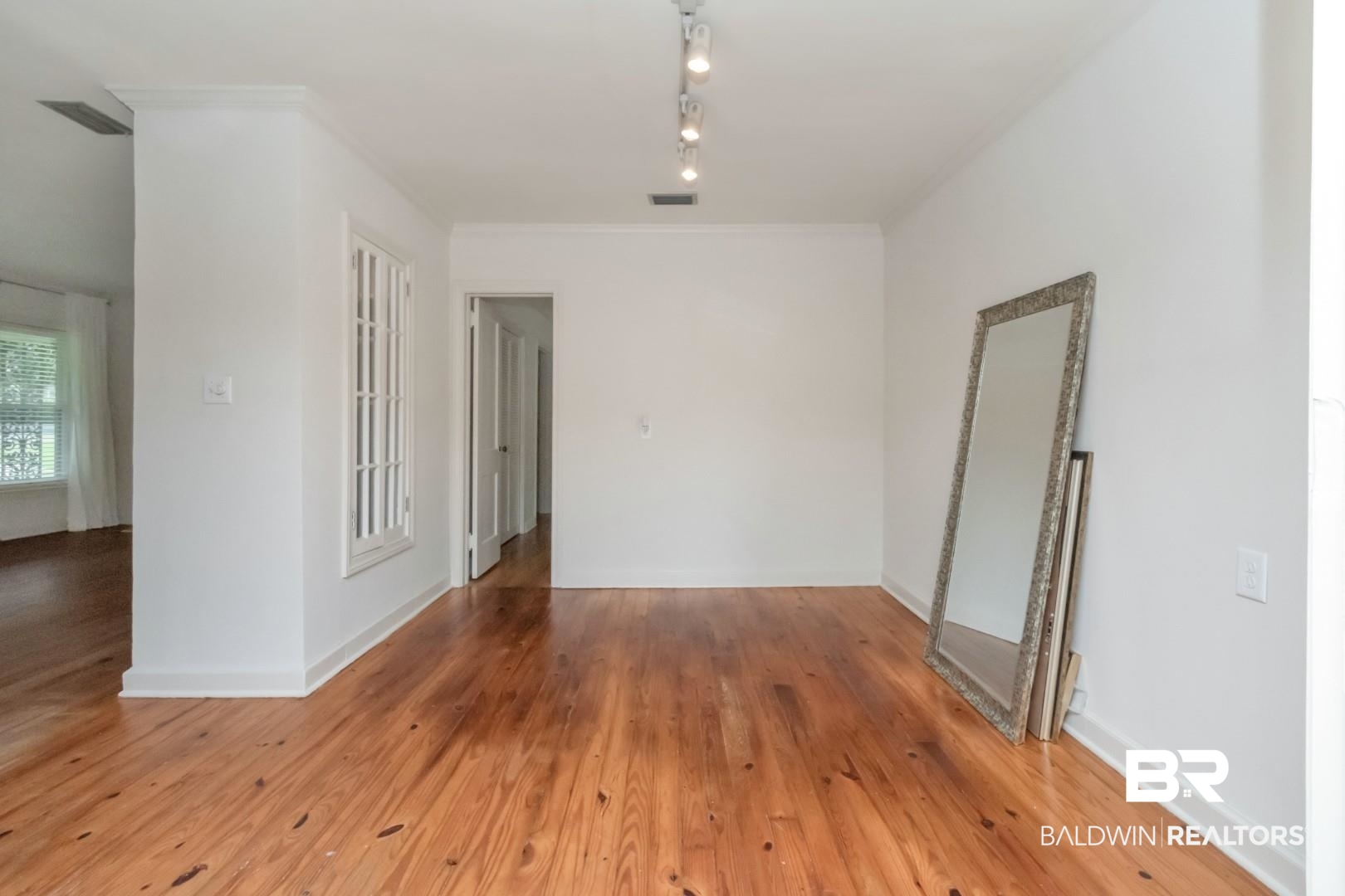 1906 Old Shell Road Mobile, AL 36607 - Photo 14 of 26 Empty room featuring track lighting and wood-type flooring