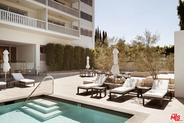 a view of a patio with couches table and chairs and potted plants