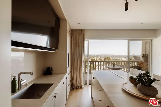 a kitchen with a sink and a refrigerator