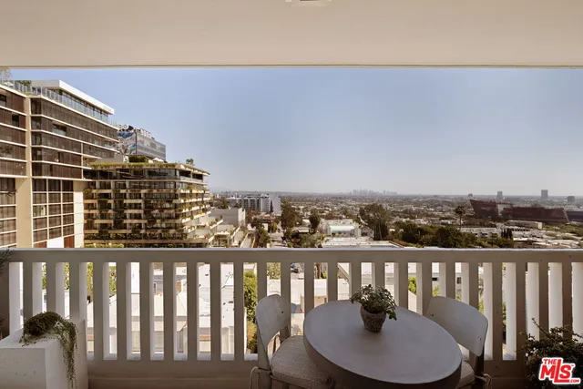 a balcony with table and chairs