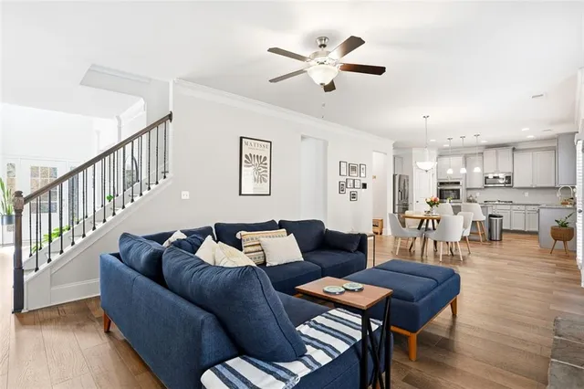 a living room with furniture and kitchen view