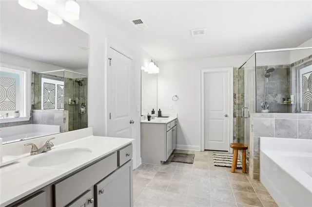 a bathroom with a tub sink and mirror