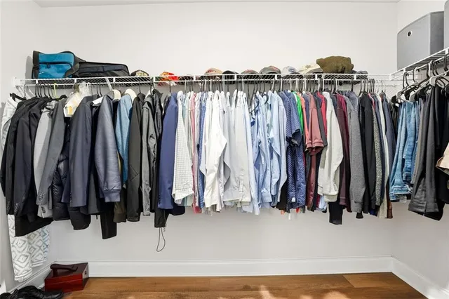 a view of walk in closet with clothes