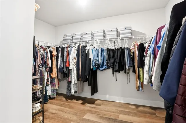 a view of walk in closet with clothes