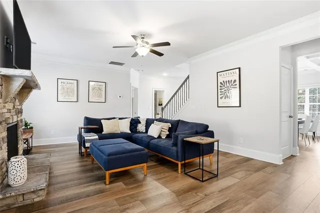 a living room with furniture and a wooden floor
