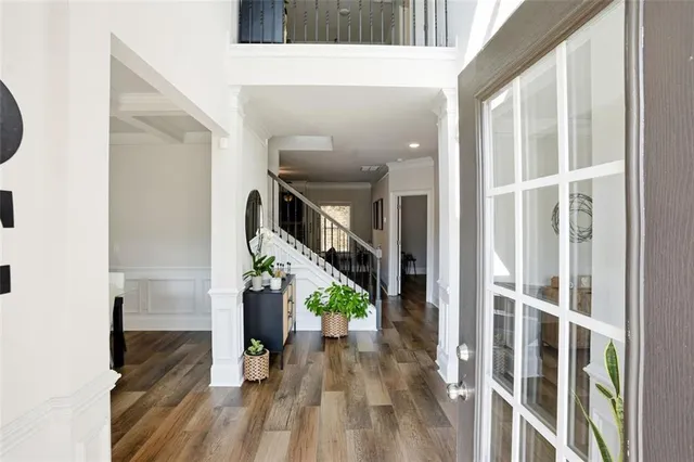 a view of entryway and hall with wooden floor