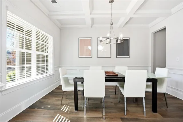 a view of a dining room with furniture wooden floor and chandelier