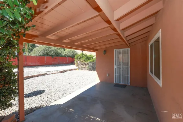 a view of a room with wooden floor and doors