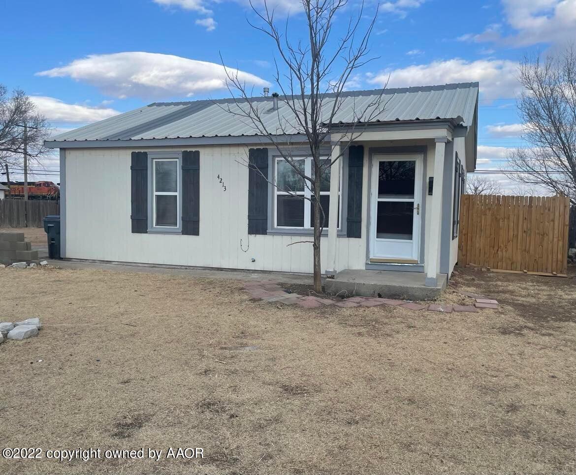 4213 South Polk Street Amarillo, TX 79110 - Photo 2 of 7 a front view of a house with garden
