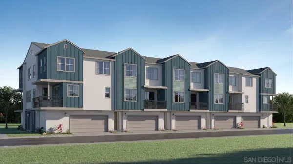 a front view of a residential apartment building with a yard