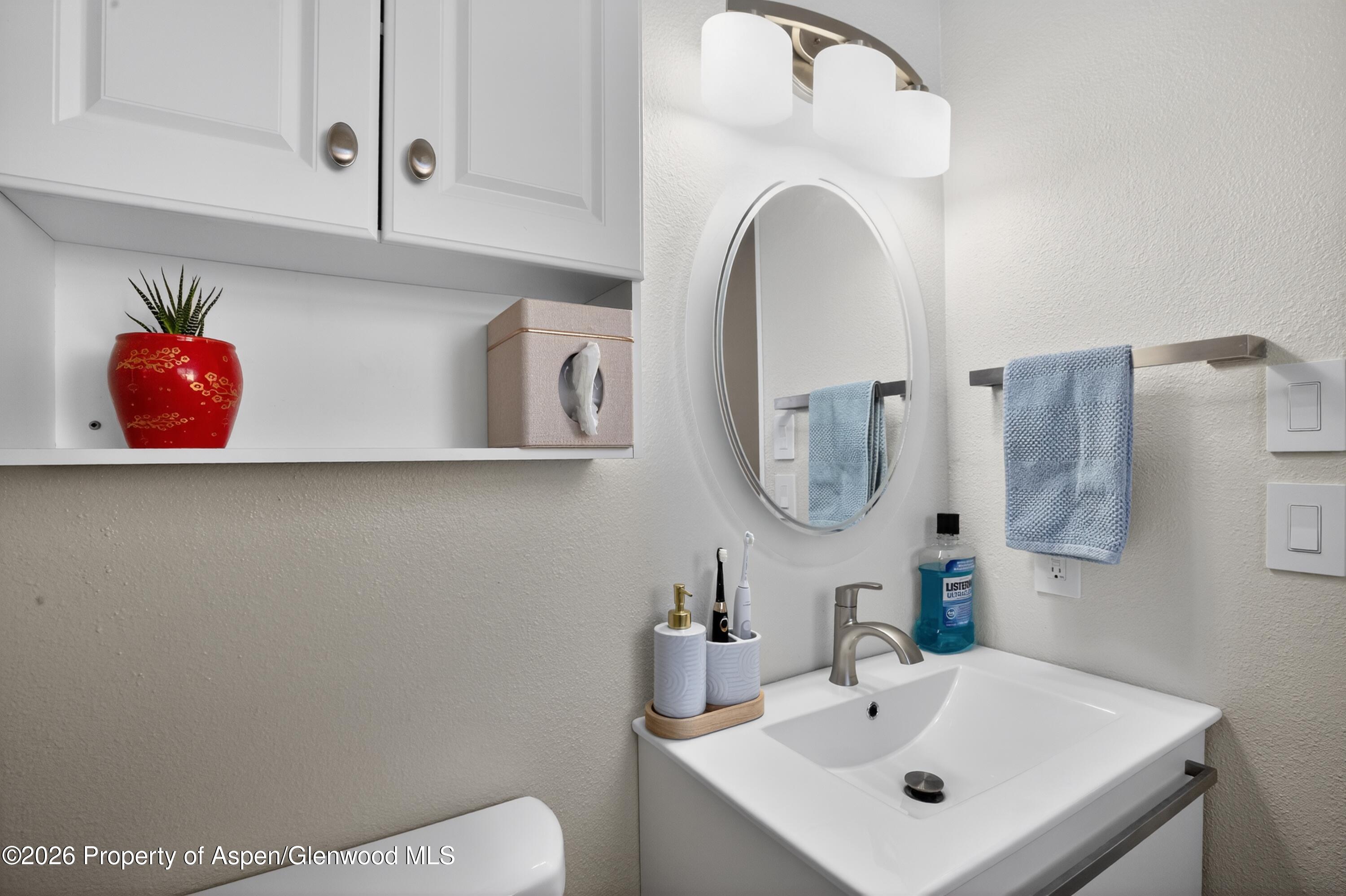 1310 Dogwood Drive Rifle, CO 81650 - Photo 19 of 49 a bathroom with a sink and a mirror