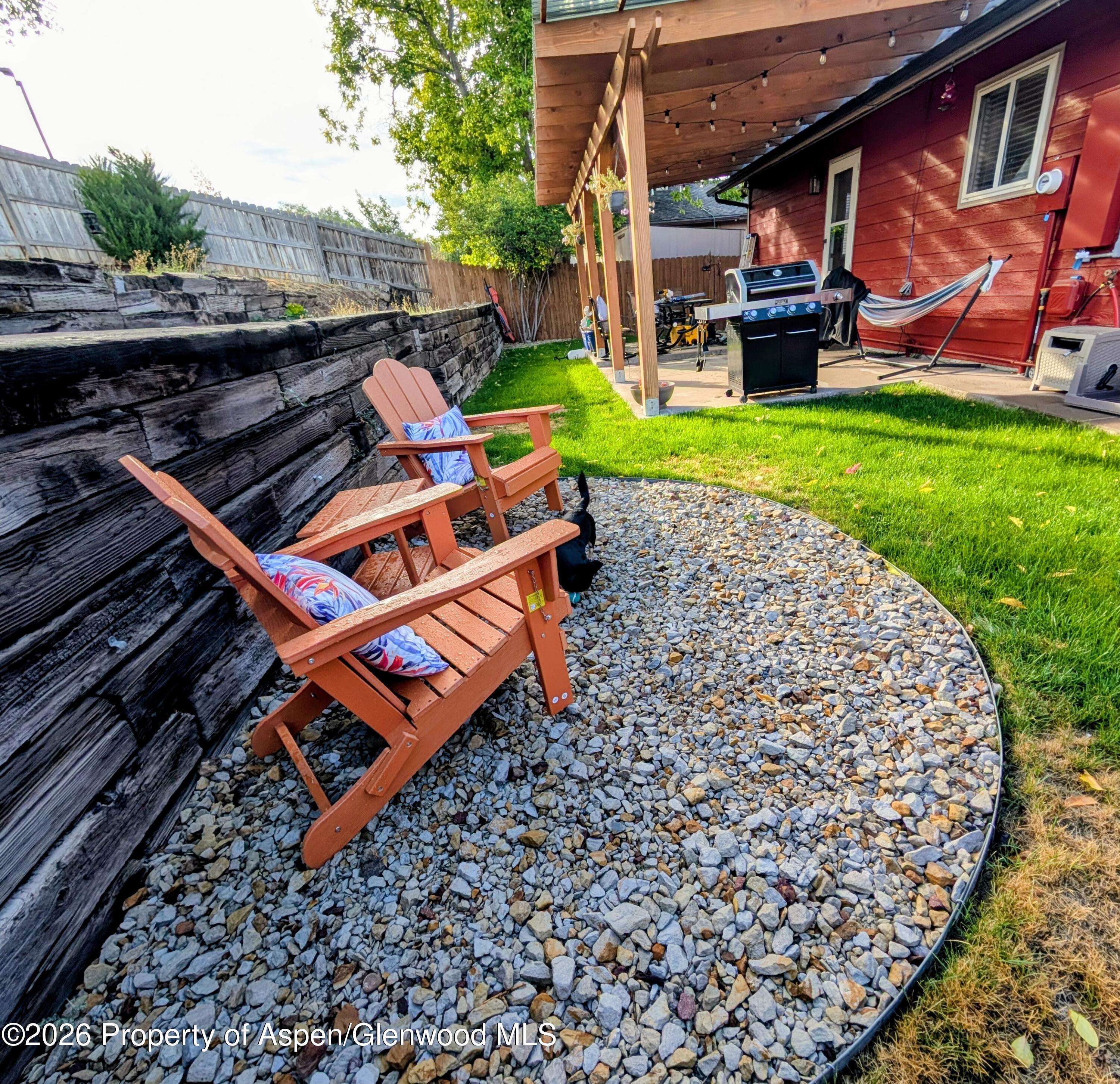 1310 Dogwood Drive Rifle, CO 81650 - Photo 42 of 49 an outdoor sitting area with a table and chairs
