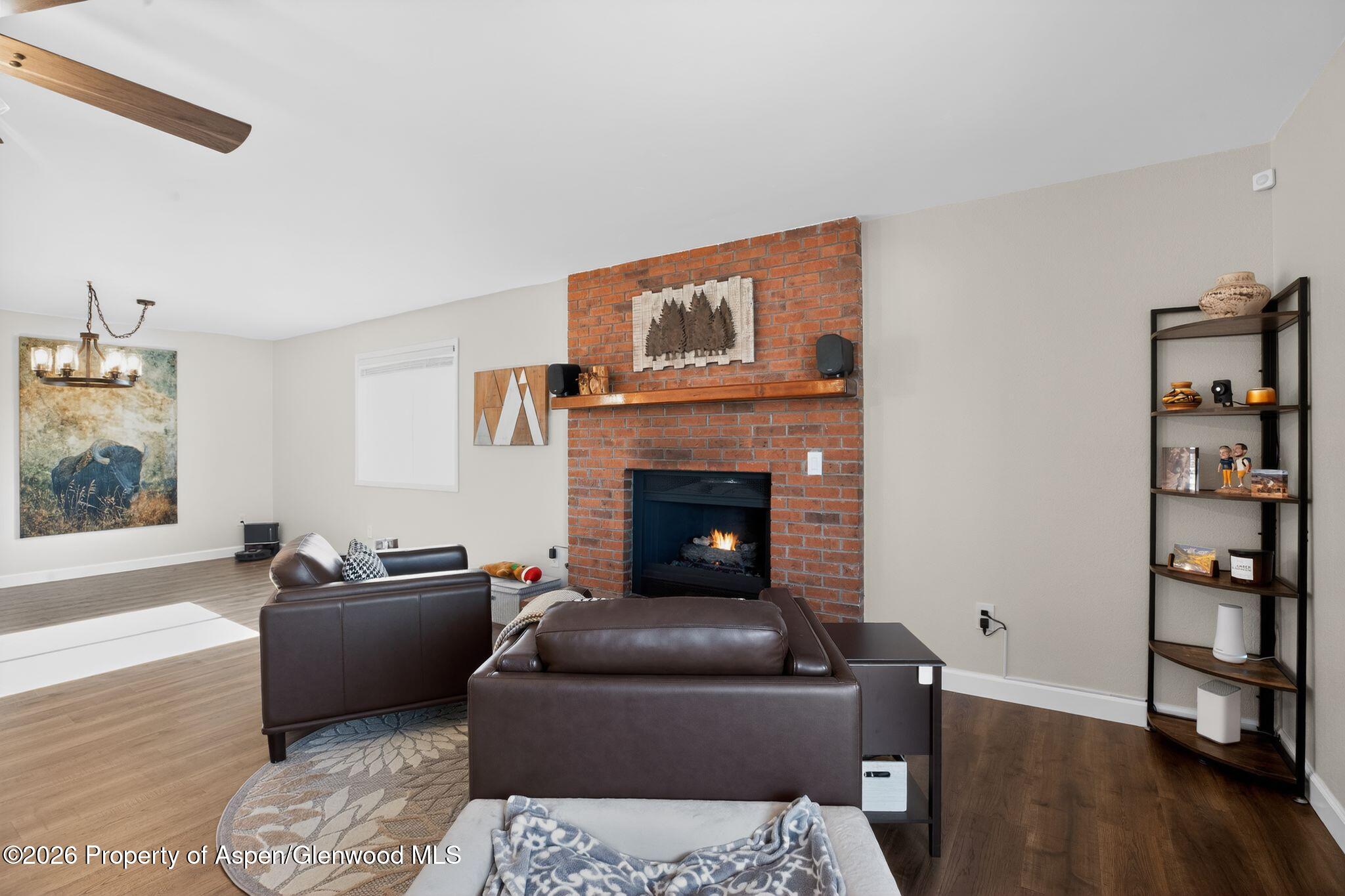 1310 Dogwood Drive Rifle, CO 81650 - Photo 8 of 49 a living room with furniture and a fireplace