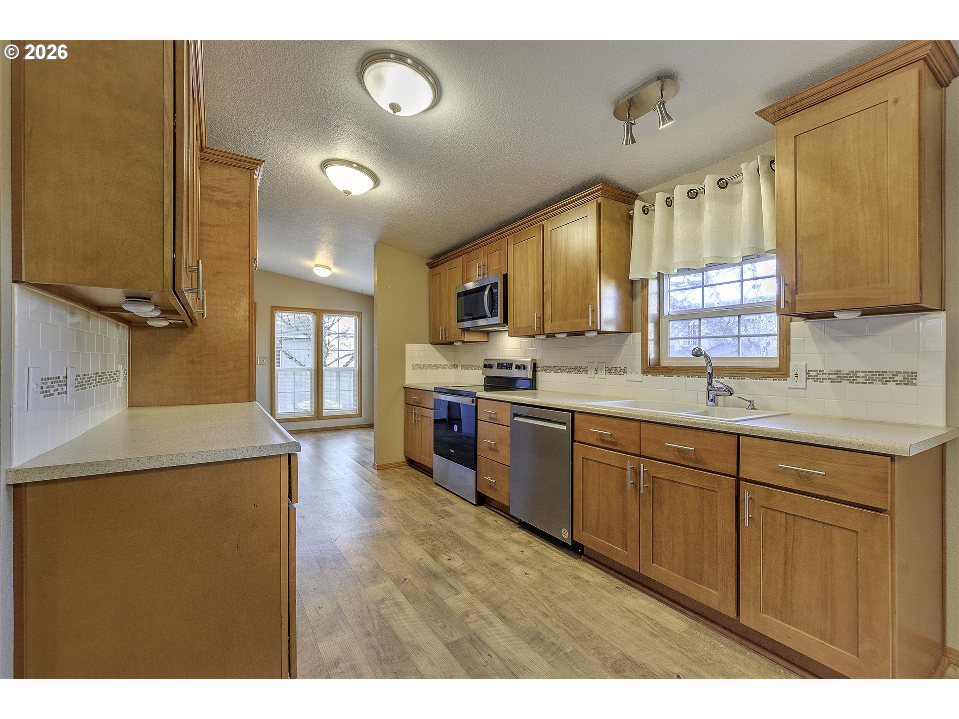 5385 Southwest 167th Avenue Beaverton, OR 97007 - Photo 13 of 29 a kitchen with stainless steel appliances granite countertop a sink stove and refrigerator