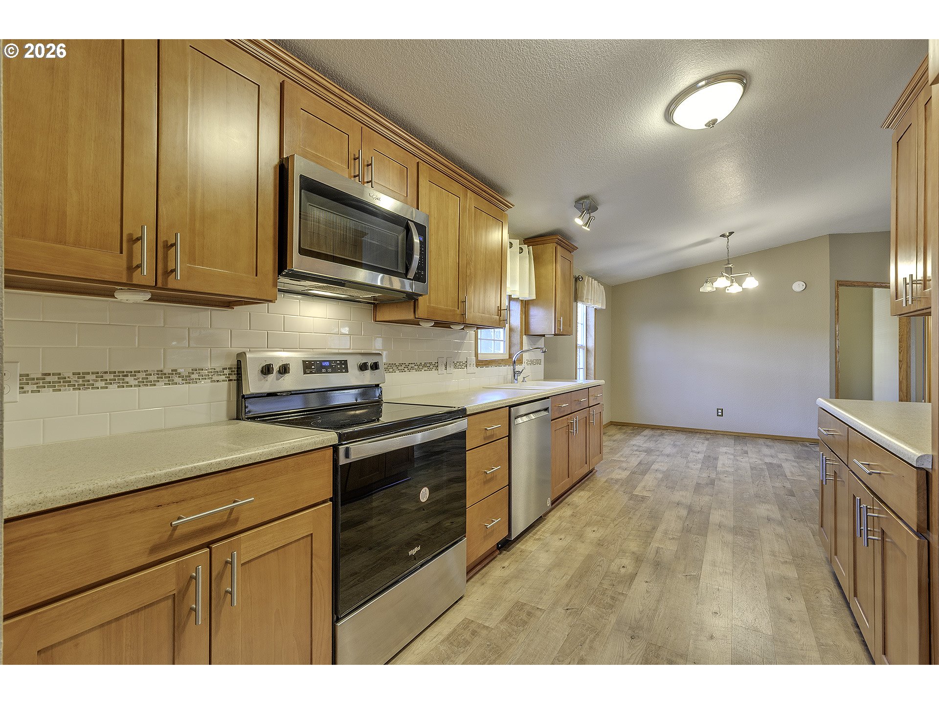 5385 Southwest 167th Avenue Beaverton, OR 97007 - Photo 14 of 29 a kitchen with stainless steel appliances granite countertop a sink a stove and a microwave