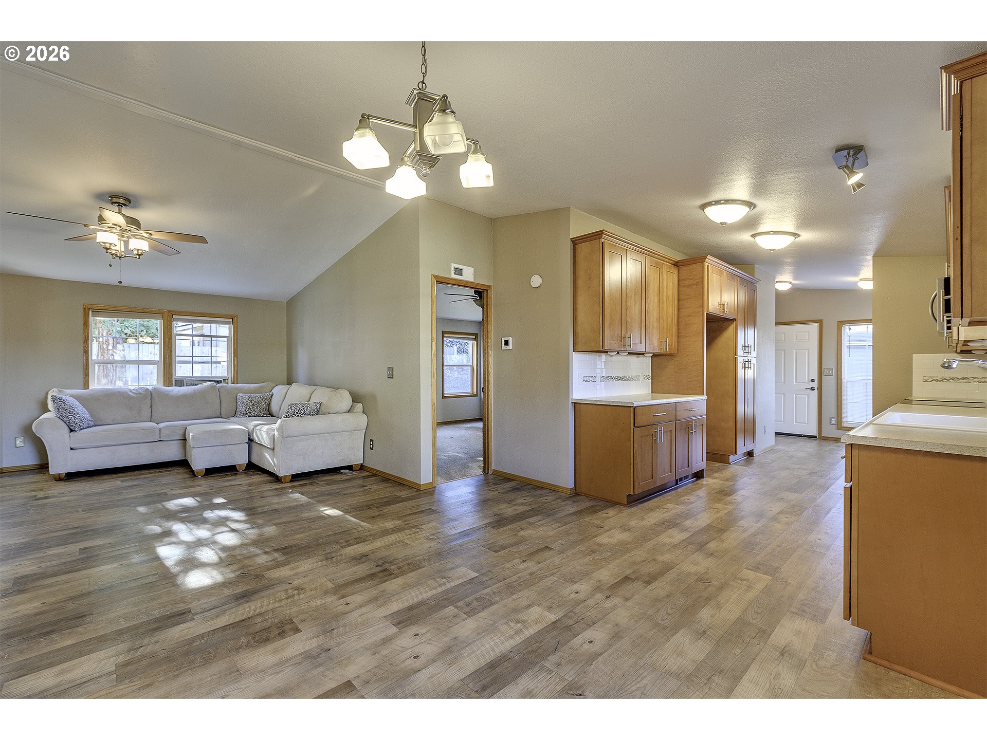 5385 Southwest 167th Avenue Beaverton, OR 97007 - Photo 8 of 29 a living room with furniture and a chandelier