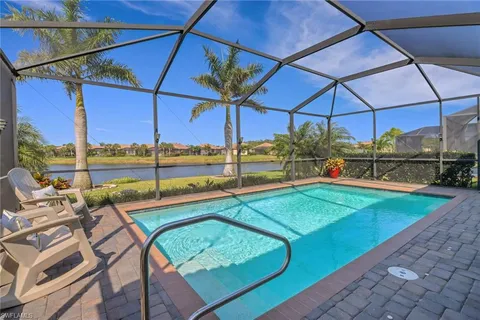a view of a patio with a table and chairs under an umbrella