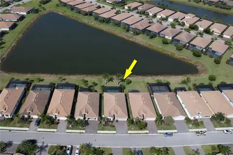 an aerial view of residential houses with outdoor space and swimming pool