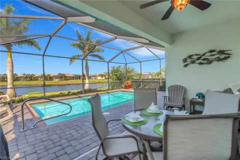 a dining room with furniture and chandelier fan kitchen view