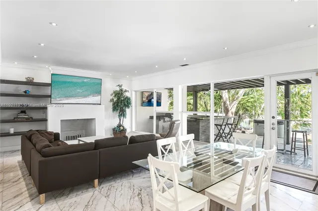 a living room with furniture fireplace and a large window
