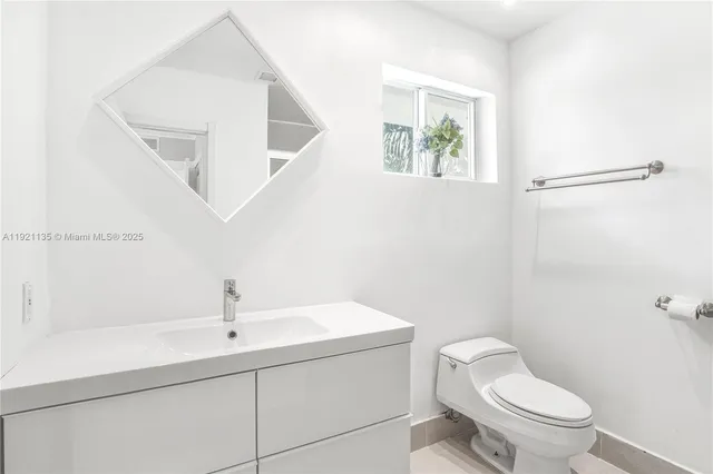 a white toilet sitting next to a bathroom sink
