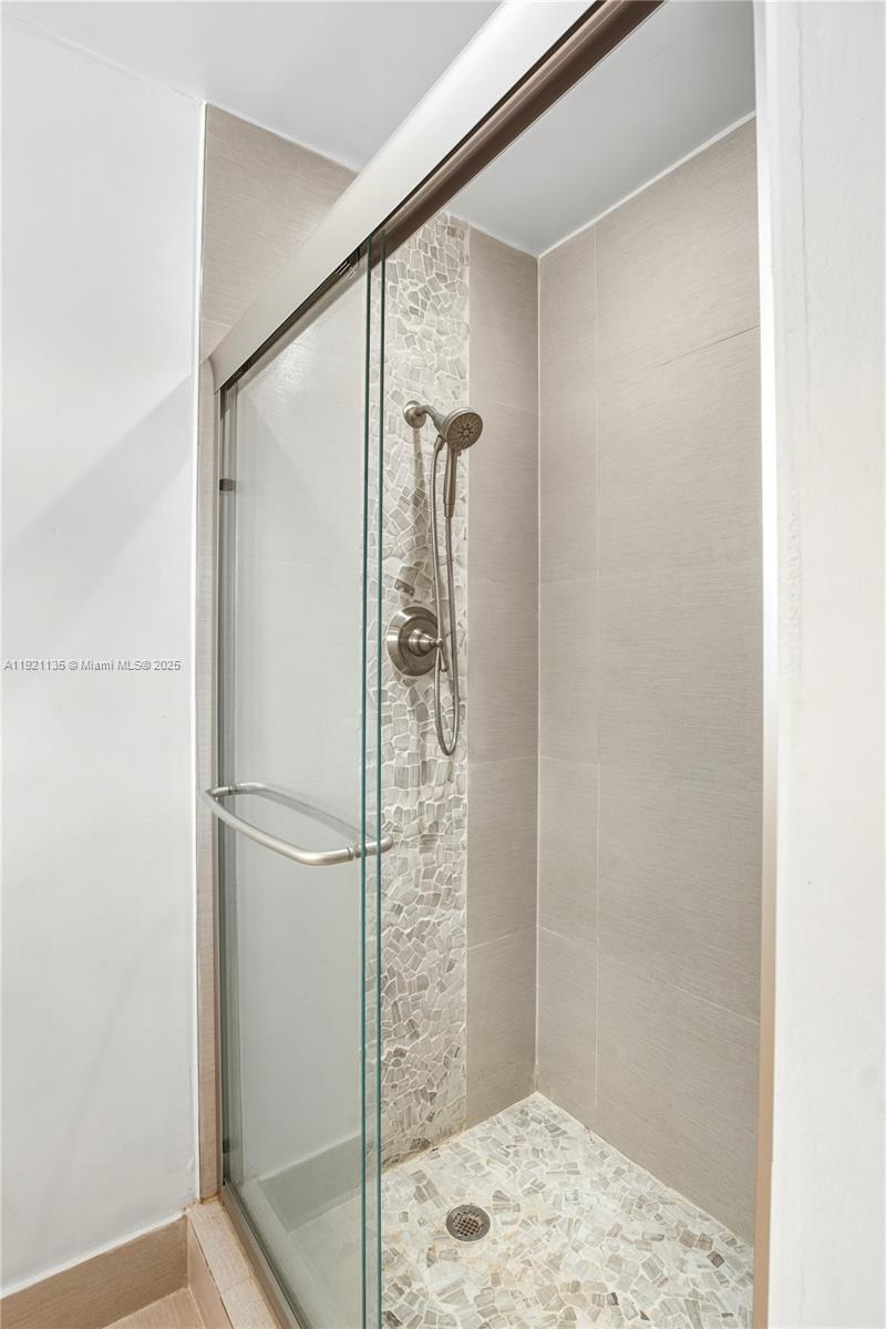 12545 Palm Road North Miami, FL 33181 - Photo 22 of 31 a bathroom with a glass shower door and a sink