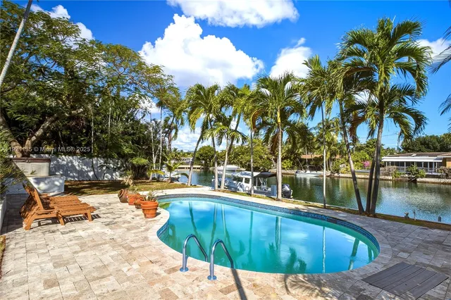a view of swimming pool with chairs
