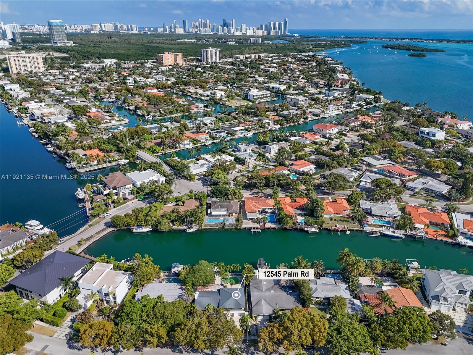 12545 Palm Road North Miami, FL 33181 - Photo 26 of 31 an aerial view of a city with lots of residential buildings ocean and mountain view in back