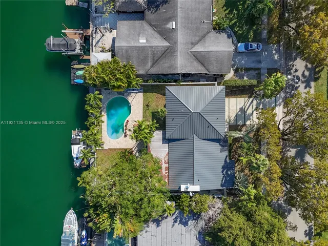 an aerial view of a house with a yard basket ball court and outdoor seating
