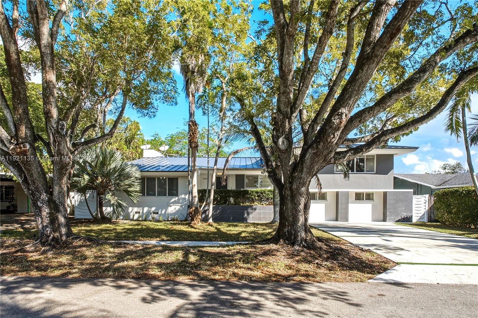 12545 Palm Road North Miami, FL 33181 - Photo 31 of 31 a view of a white house that has a tree in it