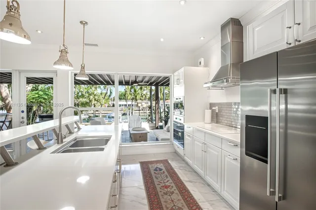a large white kitchen with a large window