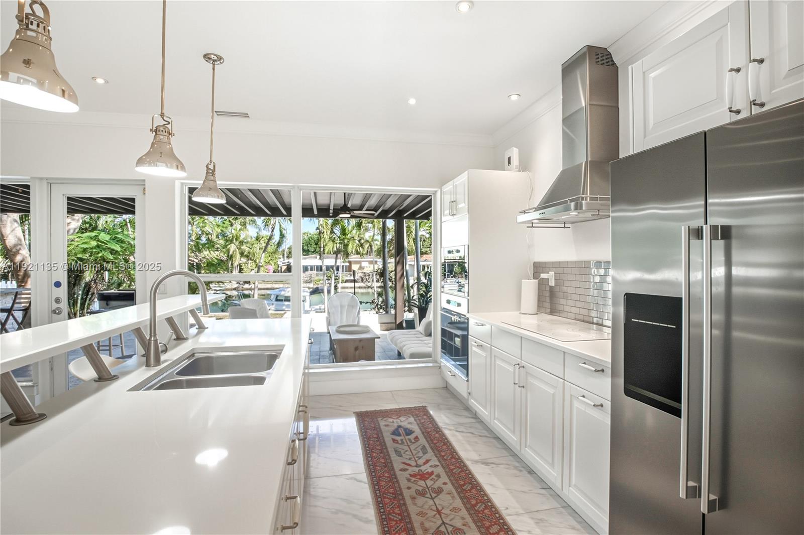 12545 Palm Road North Miami, FL 33181 - Photo 7 of 31 a large white kitchen with a large window