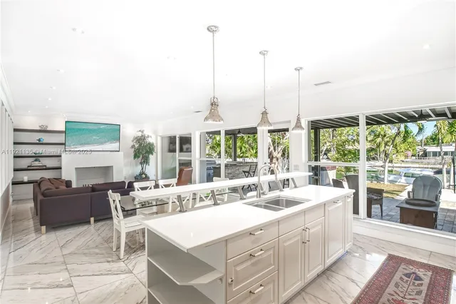 a large white kitchen with a large window