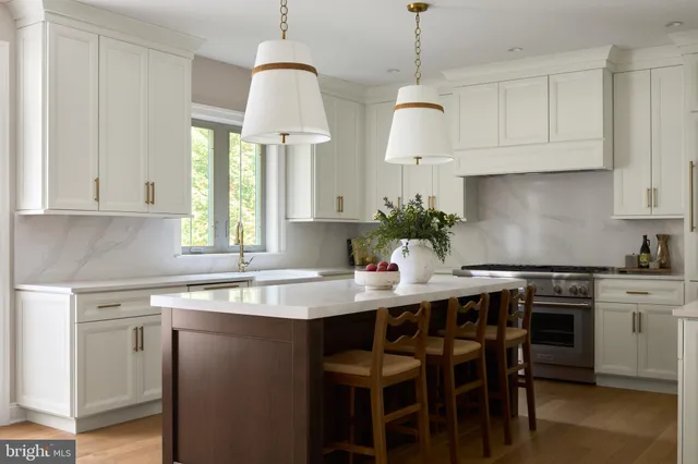 a kitchen with stainless steel appliances granite countertop a sink a stove and a window