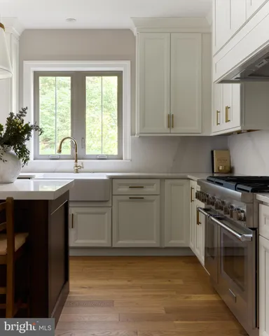 a kitchen with a sink stove and cabinets