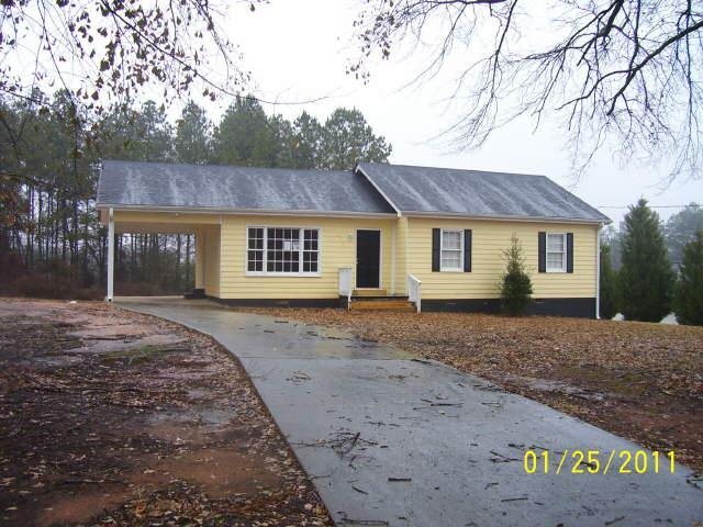 1205 East Mcintosh Road Griffin, GA 30223 - Photo 1 of 1 a front view of a house with a garden