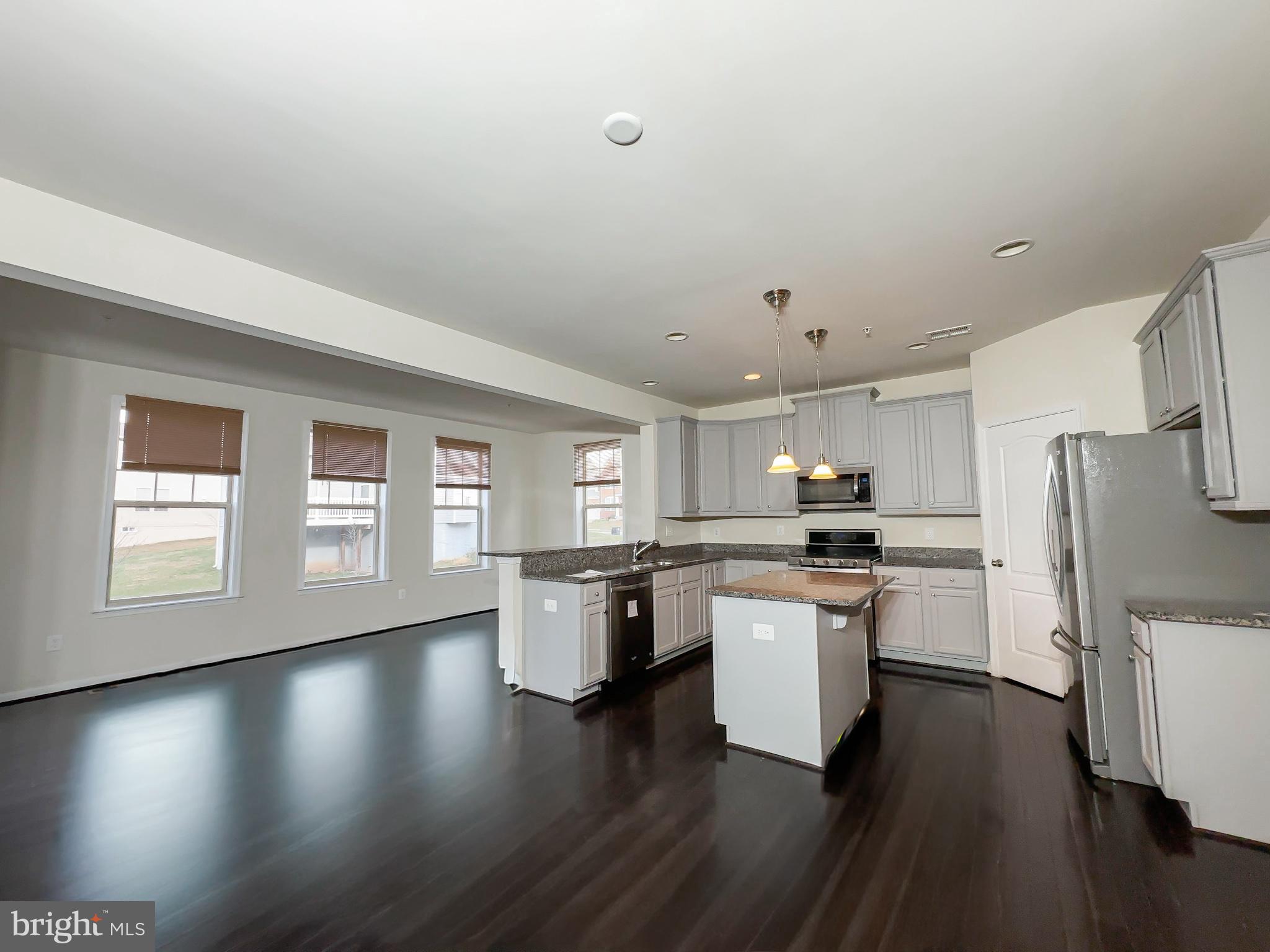 10202 Galaxy View Lane Lanham, MD 20706 - Photo 16 of 67 a kitchen with a white wooden cabinets and wooden floor