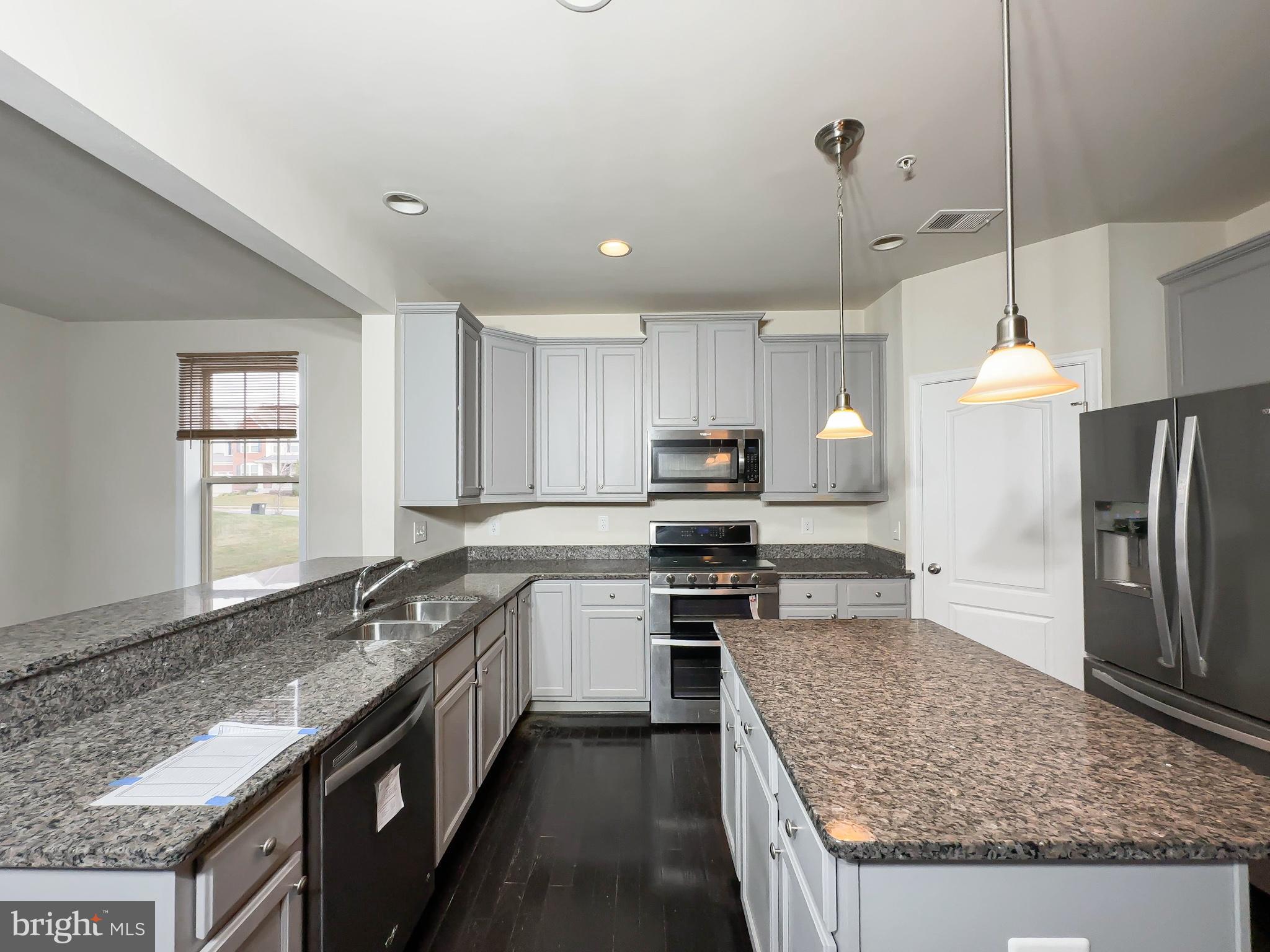 10202 Galaxy View Lane Lanham, MD 20706 - Photo 22 of 67 a kitchen with stainless steel appliances granite countertop a sink stove and refrigerator