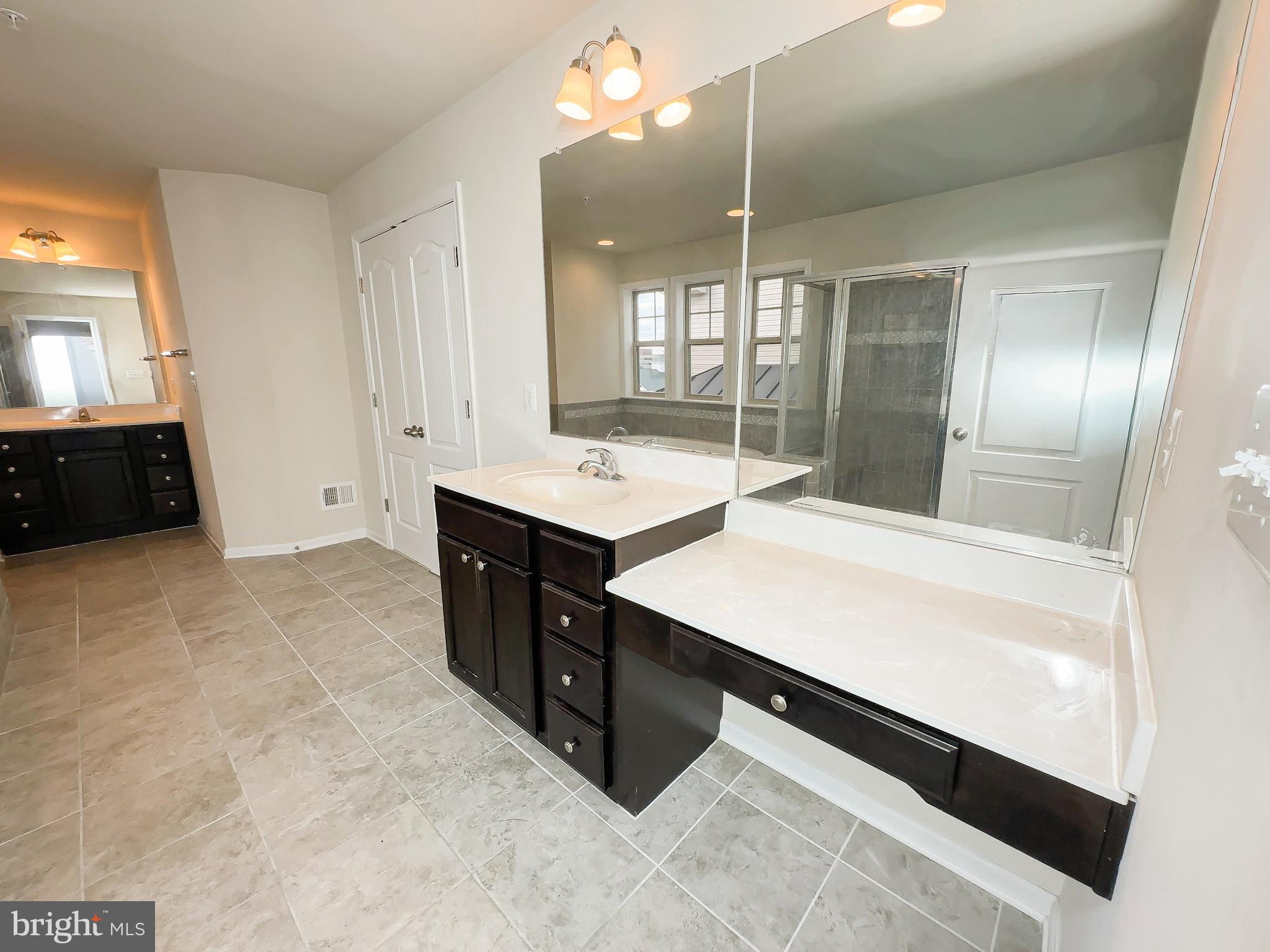 10202 Galaxy View Lane Lanham, MD 20706 - Photo 39 of 67 a bathroom with a sink double vanity and a mirror